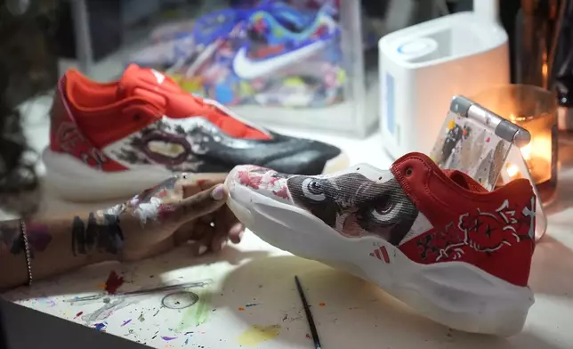 California basketball player Jayda Noble holds a shoe she is painting in Berkeley, Calif., Monday, Oct. 21, 2024. (AP Photo/Jeff Chiu)