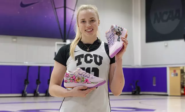 In this image provided byt TCU Athletics, TCU guard Hailey Van Lith holds up shoes painted by California basketball player Jayda Noble in Fort Worth, Texas, Monday, Dec. 16, 2024. (Zach Campbell/TCU Athletics via AP)