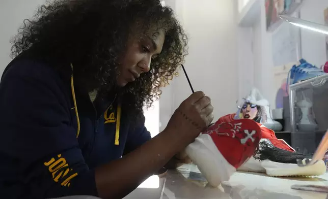 California basketball player Jayda Noble paints shoes in Berkeley, Calif., Monday, Oct. 21, 2024. (AP Photo/Jeff Chiu)