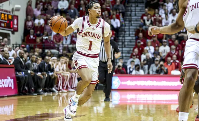 In this image provided by Indiana Athletics, Indiana guard Myles Rice is shown wearing shoes painted by California basketball player Jayda Noble as he brings the ball up the court during an NCAA college basketball game against SIU-Edwardsville, Wednesday, Nov. 6, 2024, in Bloomington, Ind. (Trent Barnhart/Indiana Athletics via AP)