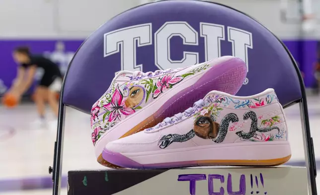 In this image provided by TCU Athletics, shoes painted by California basketball player Jayda Noble for TCU guard Hailey Van Lith are displayed in Fort Worth, Texas, Monday, Dec. 16, 2024. (Zach Campbell/TCU Athletics via AP)