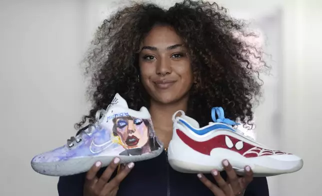 California basketball player Jayda Noble holds up shoes showing her artwork in Berkeley, Calif., Monday, Oct. 21, 2024. (AP Photo/Jeff Chiu)