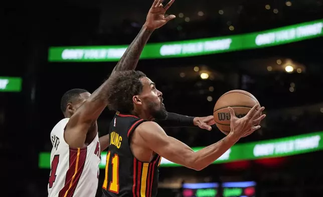 Atlanta Hawks guard Trae Young (11) shoots against the Miami Heat during the first half of an NBA basketball game, Saturday, Dec. 28, 2024, in Atlanta. (AP Photo/Mike Stewart)