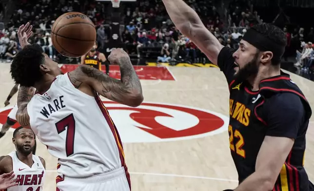 Atlanta Hawks forward Larry Nance Jr. (22) dunks the ball against Miami Heat center Kel'el Ware (7) during the first half of an NBA basketball game, Saturday, Dec. 28, 2024, in Atlanta. (AP Photo/Mike Stewart)