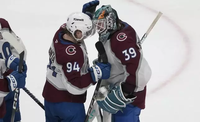 Colorado Avalanche left wing Joel Kiviranta (94) celebrates with goaltender Mackenzie Blackwood (39) after an NHL hockey game against the San Jose Sharks in San Jose, Calif., Thursday, Dec. 19, 2024. (AP Photo/Jeff Chiu)