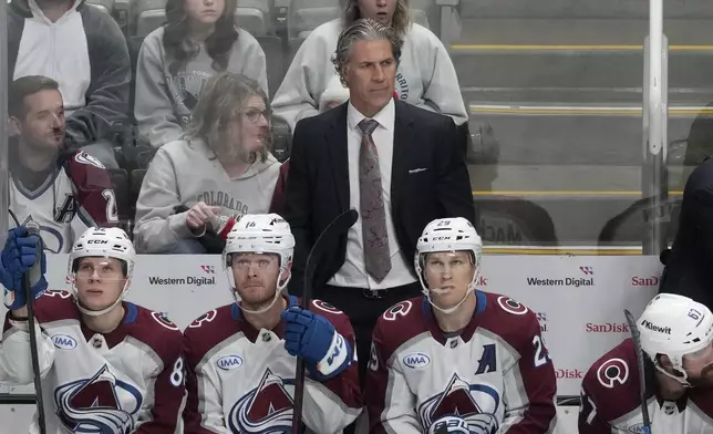 Colorado Avalanche head coach Jared Bednar, standing, watches from the bench during the third period of an NHL hockey game against the San Jose Sharks in San Jose, Calif., Thursday, Dec. 19, 2024. (AP Photo/Jeff Chiu)