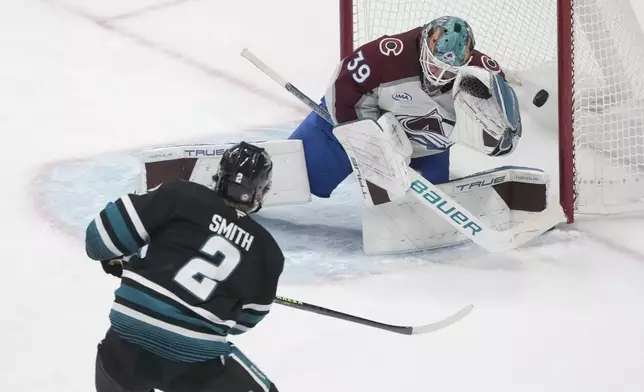 Colorado Avalanche goaltender Mackenzie Blackwood (39) defends against a shot by San Jose Sharks center Will Smith (2) during the third period of an NHL hockey game in San Jose, Calif., Thursday, Dec. 19, 2024. (AP Photo/Jeff Chiu)