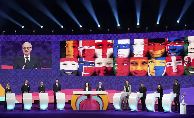 UEFA deputy general secretary Giorgio Marchetti, on the video screen, hosts the UEFA Euro 2025 European women's soccer championship final draw at the Swiss Tech Convention Centre in Lausanne, Switzerland, Monday, Dec. 16, 2024. (AP Photo/Laurent Cipriani)