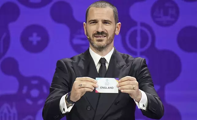 Italian soccer player Leonardo Bonucci draws England during the UEFA Euro 2025 European women's soccer championship final draw at the Swiss Tech Convention Centre in Lausanne, Switzerland, Monday, Dec. 16, 2024. (AP Photo/Laurent Cipriani)