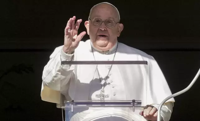 Pope Francis delivers his blessing as he recites the Angelus noon prayer from the window of his studio overlooking St.Peter's Square, at the Vatican, Thursday, Dec. 26, 2024. (AP Photo/Andrew Medichini)