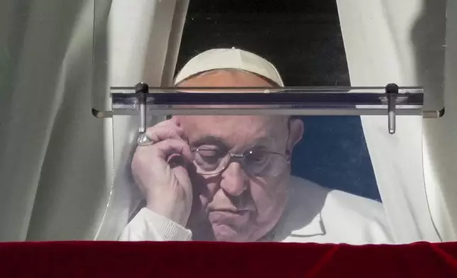 Pope Francis arrives to recite the Angelus noon prayer from the window of his studio overlooking St. Peter's Square, at the Vatican, Thursday, Dec. 26, 2024. (AP Photo/Andrew Medichini)