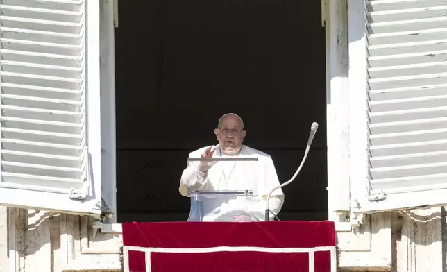 Pope Francis delivers his blessing as he recites the Angelus noon prayer from the window of his studio overlooking St.Peter's Square, at the Vatican, Thursday, Dec. 26, 2024. (AP Photo/Andrew Medichini)