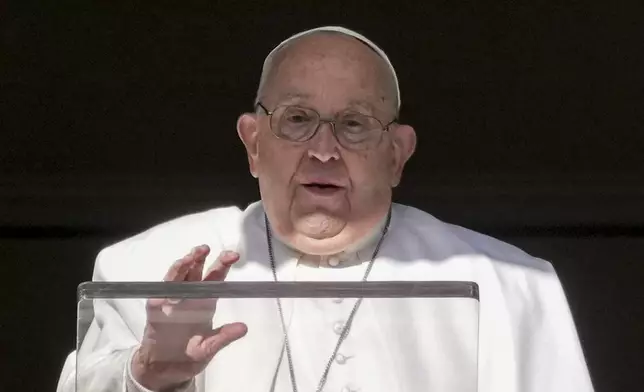 Pope Francis delivers his blessing as he recites the Angelus noon prayer from the window of his studio overlooking St.Peter's Square, at the Vatican, Thursday, Dec. 26, 2024. (AP Photo/Andrew Medichini)