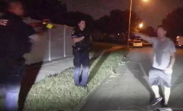 In this image from video provided by the Bismarck Police Department, officers, one pointing a Taser, confront Ryan Pederson in Bismarck, N.D., on Aug. 7, 2021. (Bismarck Police Department via AP)