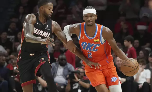 Miami Heat forward Haywood Highsmith (24) defends Oklahoma City Thunder guard Shai Gilgeous-Alexander (2) during the second half of an NBA basketball game, Friday, Dec. 20, 2024, in Miami. (AP Photo/Marta Lavandier)