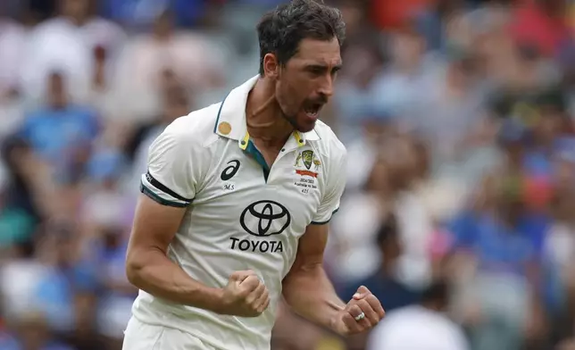 Australia's Mitchell Starc celebrates the dismissal of India's Virat Kohli during the day one of the second cricket test match between Australia and India at the Adelaide Oval in Adelaide, Australia, Friday, Dec. 6, 2024. (AP Photo/James Elsby)