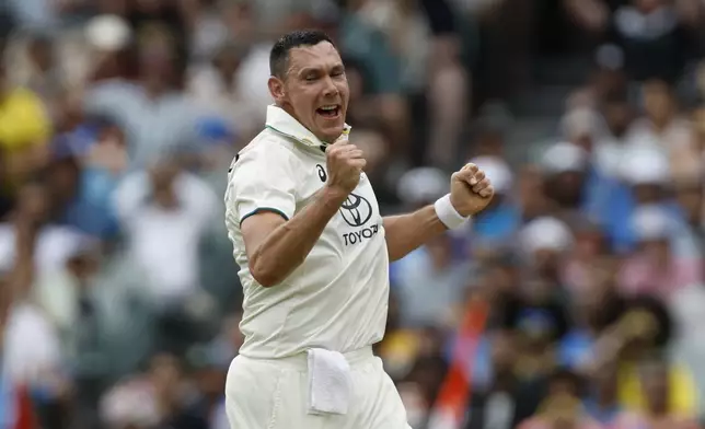 Australia's Scott Boland celebrates the dismissal of India's Shubman Gill during the day one of the second cricket test match between Australia and India at the Adelaide Oval in Adelaide, Australia, Friday, Dec. 6, 2024. (AP Photo/James Elsby)