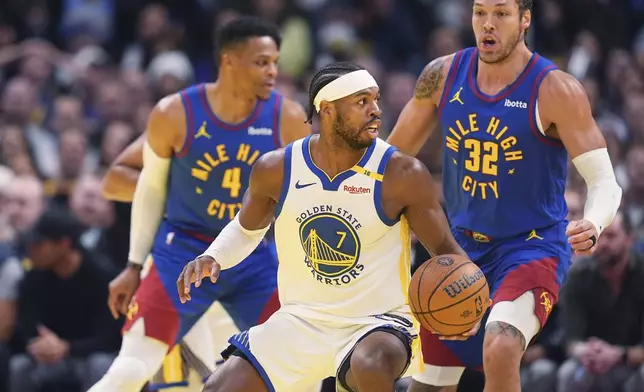 Golden State Warriors guard Buddy Hield, front, looks to pass the ball as Denver Nuggets guard Russell Westbrook, back left, and forward Aaron Gordon defend in the first half of an Emirates NBA Cup basketball game Tuesday, Dec. 3, 2024, in Denver. (AP Photo/David Zalubowski)