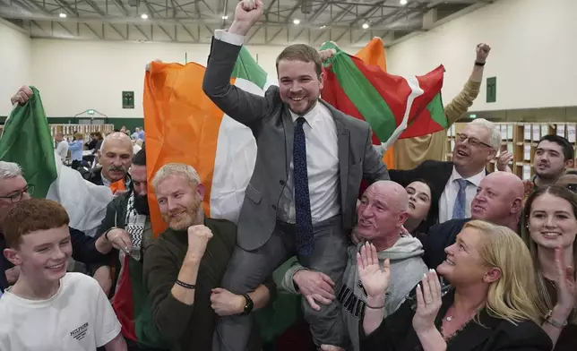 Sinn Fein's Donnchadh O Laoghaire, celebrates being elected for Cork South-Central, at Nemo Rangers GAA Club in Cork, as the election count continues for the Irish General Election, Sunday Dec. 1, 2024. (Jacob King/PA via AP)