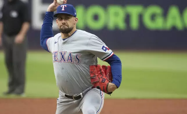 FILE - Texas Rangers starting pitcher Nathan Eovaldi delivers against the Cleveland Guardians during the first inning of a baseball game in Cleveland, Friday, Aug. 23, 2024. (AP Photo/Phil Long, File)