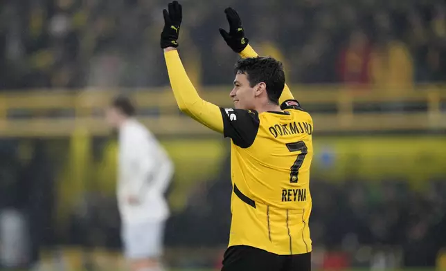 Dortmund's Giovanni Reyna celebrates after scoring the opening goal during the German Bundesliga soccer match between Borussia Dortmund and TSG Hoffenheim at the Signal-Iduna Park in Dortmund, Germany, Sunday, Dec. 15 2024. (AP Photo/Martin Meissner)