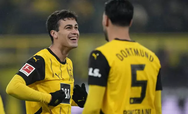 Dortmund's Giovanni Reyna, left, celebrates after scoring the opening goal during the German Bundesliga soccer match between Borussia Dortmund and TSG Hoffenheim at the Signal-Iduna Park in Dortmund, Germany, Sunday, Dec. 15 2024. (AP Photo/Martin Meissner)