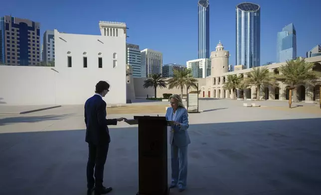 A secret service agent stands by as the First lady Jill Biden signs the guest book during her visit to Kasr Al Hosn Fort in Abu Dhabi, United Arab Emirates, Thursday, Dec. 5, 2024. (AP Photo/Altaf Qadri)