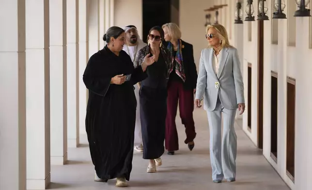 First lady Jill Biden, right, and her daughter Ashley Biden, behind, walk during a visit to the Kasr Al Hosn Fort in Abu Dhabi, United Arab Emirates, Thursday, Dec. 5, 2024. (AP Photo/Altaf Qadri)