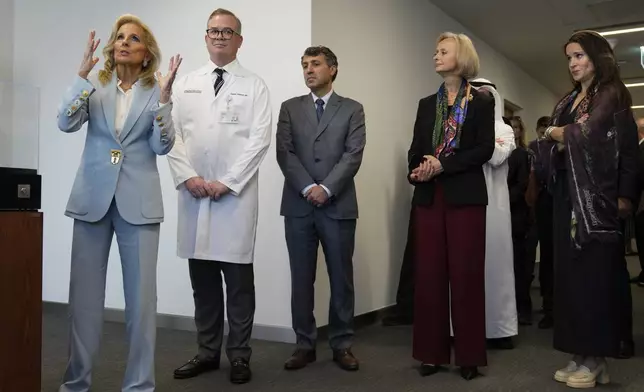 First lady Jill Biden, left, speaks to the medical staff at Cleveland Clinic in Abu Dhabi, United Arab Emirates, Thursday, Dec. 5, 2024. (AP Photo/Altaf Qadri)