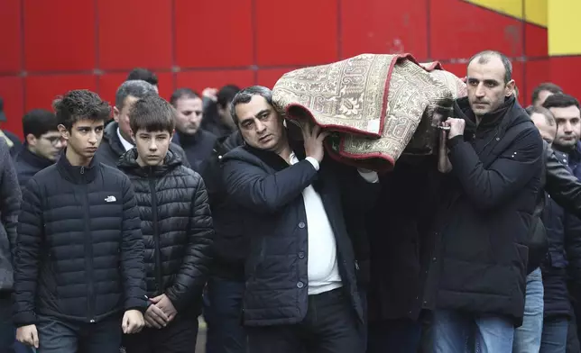 People attend a funeral of Mahammadali Eganov who died in the Azerbaijan Airlines Embraer 190 crash near the Kazakhstan's airport of Aktau at the age of 13, in Baku, Azerbaijan, Saturday, Dec. 28, 2024. (AP Photo)