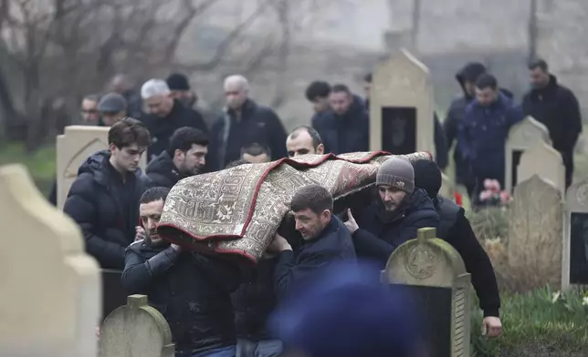 People attend a funeral of Mahammadali Eganov who died in the Azerbaijan Airlines Embraer 190 crash near the Kazakhstan's airport of Aktau at the age of 13, in Baku, Azerbaijan, Saturday, Dec. 28, 2024. (AP Photo)