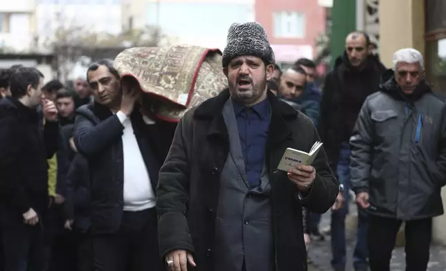 People attend a funeral of Mahammadali Eganov who died in the Azerbaijan Airlines Embraer 190 crash near the Kazakhstan's airport of Aktau at the age of 13, in Baku, Azerbaijan, Saturday, Dec. 28, 2024. (AP Photo)