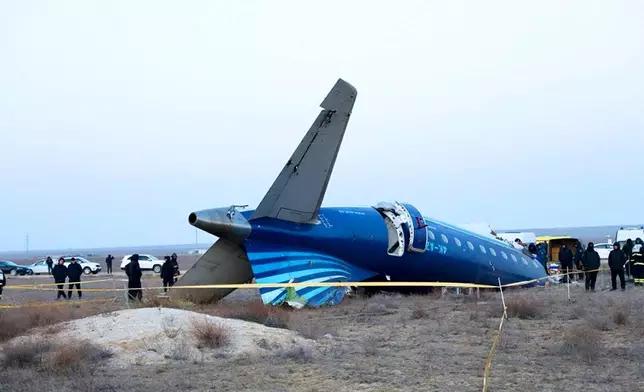 In this photo taken from a video released by the administration of Mangystau region, a part of Azerbaijan Airlines' Embraer 190 lies on the ground near the airport of Aktau, Kazakhstan, on Thursday, Dec. 26, 2024. (The Administration of Mangystau Region via AP)