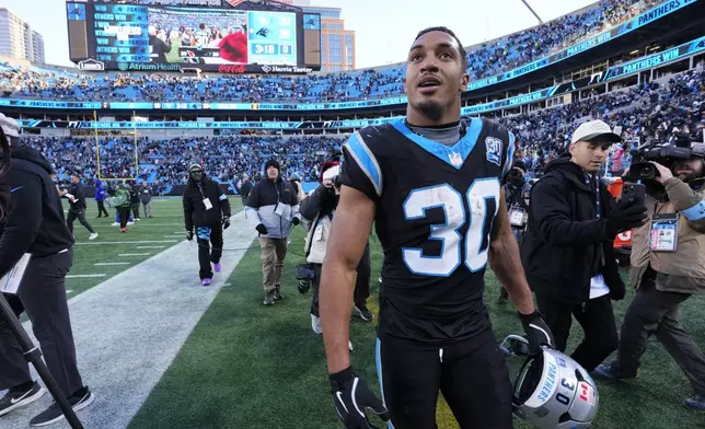 Carolina Panthers running back Chuba Hubbard leaves the field after scoring the winning touchdown against the Arizona Cardinals during overtime of an NFL football game, Sunday, Dec. 22, 2024, in Charlotte, N.C. (AP Photo/Rusty Jones)