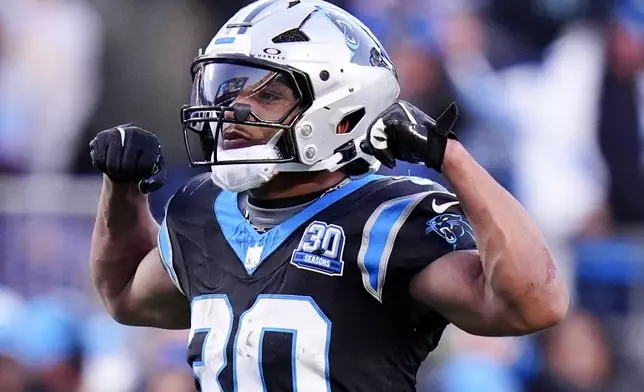 Carolina Panthers running back Chuba Hubbard celebrates after a long run against the Arizona Cardinals during overtime of an NFL football game, Sunday, Dec. 22, 2024, in Charlotte, N.C. (AP Photo/Rusty Jones)