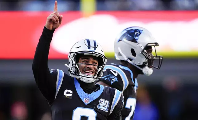 Carolina Panthers quarterback Bryce Young celebrates after a touchdown by wide receiver David Moore during the second half of an NFL football game against the Arizona Cardinals, Sunday, Dec. 22, 2024, in Charlotte, N.C. (AP Photo/Jacob Kupferman)