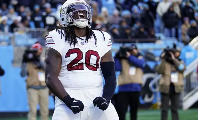 Arizona Cardinals running back DeeJay Dallas celebrates after scoring against the Carolina Panthers during the first half of an NFL football game, Sunday, Dec. 22, 2024, in Charlotte, N.C. (AP Photo/Jacob Kupferman)