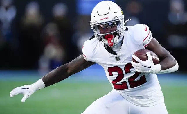 Arizona Cardinals running back Michael Carter runs against the Carolina Panthers during the second half of an NFL football game, Sunday, Dec. 22, 2024, in Charlotte, N.C. (AP Photo/Jacob Kupferman)