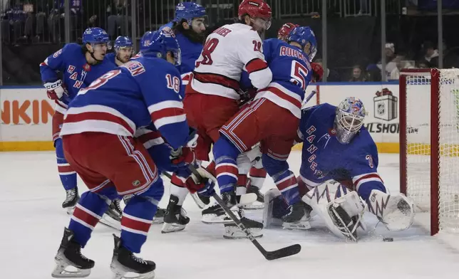 New York Rangers goaltender Igor Shesterkin (31) protects the net from Carolina Hurricanes' William Carrier (28) during the first period of an NHL hockey game Sunday, Dec. 22, 2024, in New York. (AP Photo/Frank Franklin II)