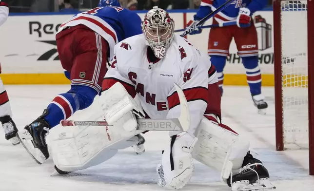 Carolina Hurricanes goaltender Pyotr Kochetkov (52) protects the net during the second period of an NHL hockey game against the New York Rangers Sunday, Dec. 22, 2024, in New York. (AP Photo/Frank Franklin II)