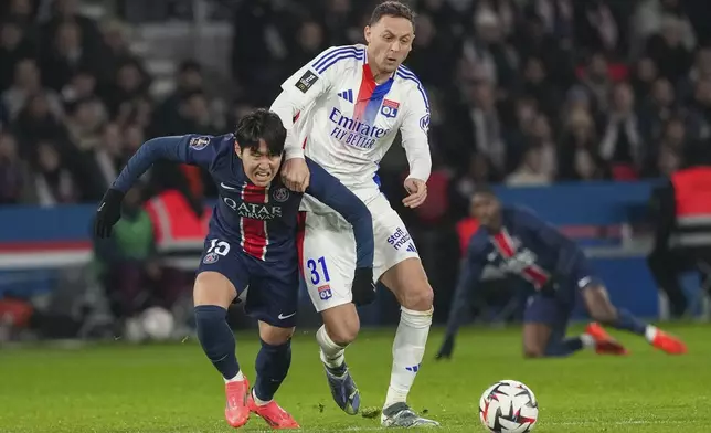 PSG's Lee Kang-in, left, challenges Lyon's Nemanja Matic during the French League One soccer match between Paris Saint-Germain and Lyon at the Parc des Princes in Paris, Sunday, Dec. 15, 2024. (AP Photo/Aurelien Morissard)
