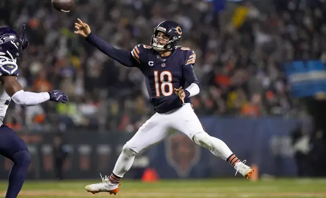 Chicago Bears quarterback Caleb Williams attempts a pass against the Seattle Seahawks during the first half of an NFL football game, Thursday, Dec. 26, 2024, in Chicago. (AP Photo/Nam Y. Huh)