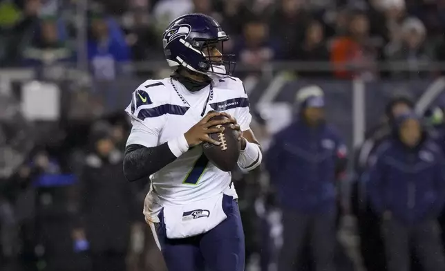 Seattle Seahawks quarterback Geno Smith looks to pass against the Chicago Bears during the first half of an NFL football game, Thursday, Dec. 26, 2024, in Chicago. (AP Photo/Nam Y. Huh)