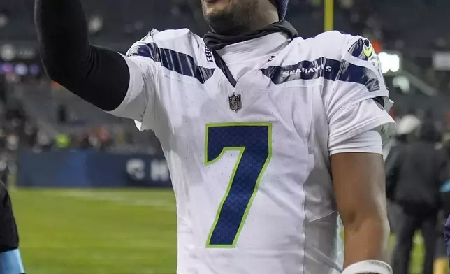 Seattle Seahawks quarterback Geno Smith (7) holds a cell phone following an NFL football game against the Chicago Bears, Thursday, Dec. 26, 2024, in Chicago. The Seahawks won 6-3. (AP Photo/Erin Hooley)