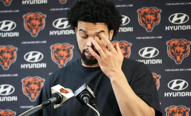 Chicago Bears quarterback Caleb Williams wipes his eyes as he talks with reporters after an NFL football game against the Seattle Seahawks, Thursday, Dec. 26, 2024, in Chicago. (AP Photo/Nam Y. Huh)