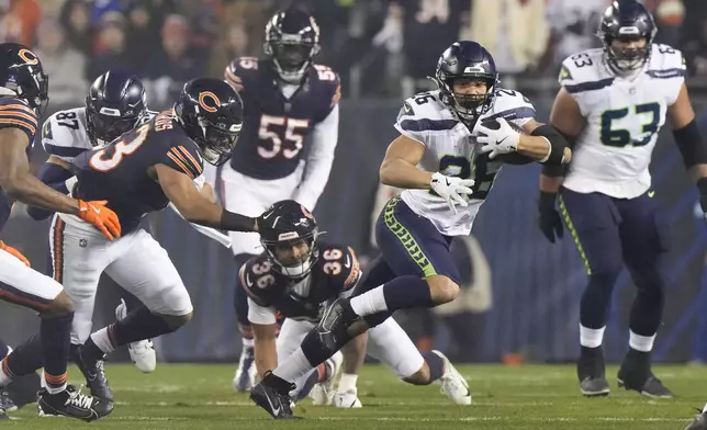 Seattle Seahawks running back Zach Charbonnet (26) runs with the ball against the Chicago Bears during the first half of an NFL football game, Thursday, Dec. 26, 2024, in Chicago. (AP Photo/Nam Y. Huh)