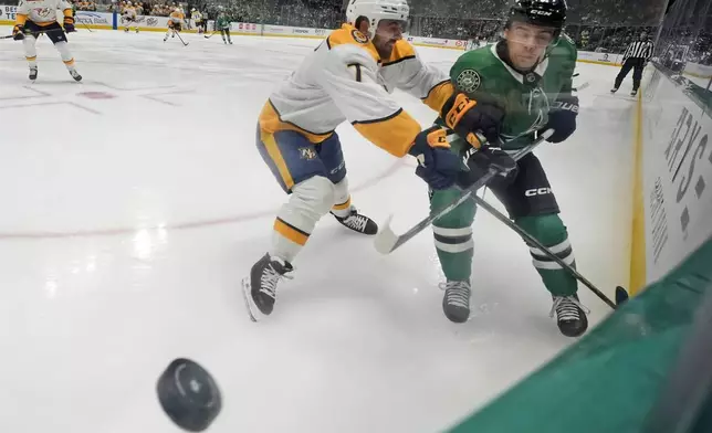 Nashville Predators defenseman Marc Del Gaizo (7) and Dallas Stars center Logan Stankoven (11) skate for control of the puck in the first period of an NHL hockey game Thursday, Dec. 12, 2024, in Dallas. (AP Photo/LM Otero)
