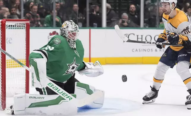 Dallas Stars goaltender Jake Oettinger (29) defends the goal against Nashville Predators center Tommy Novak (82) during the second period of an NHL hockey game Thursday, Dec. 12, 2024, in Dallas. (AP Photo/LM Otero)