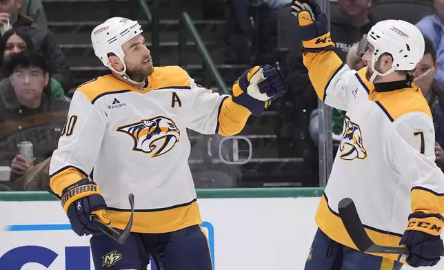Nashville Predators center Ryan O'Reilly (90) celebrates his goal with teammate Marc Del Gaizo (7) in the second period of an NHL hockey game against the Dallas Stars Thursday, Dec. 12, 2024, in Dallas. (AP Photo/LM Otero)