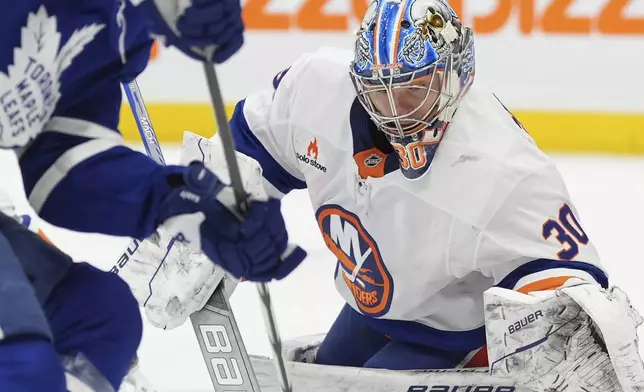 New York Islanders goaltender Ilya Sorokin (30) watches a Toronto Maple Leafs player control the puck at the side of his net during the second period of an NHL hockey game in Toronto, Saturday, Dec. 21, 2024. (Frank Gunn/The Canadian Press via AP)